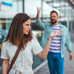Woman Annoyed While Being Confronted by Man in Urban Setting