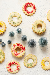 Christmas cookies lemon rings with colorful sprinkles on a Christmas rustic background