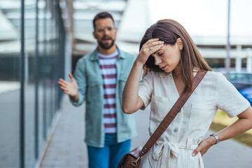 Couple Engaged in a Heated Argument in an Urban Outdoor Setting