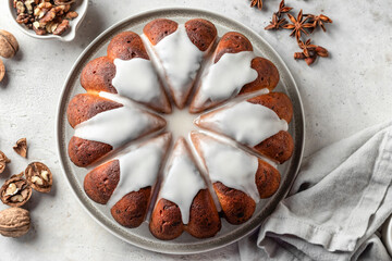 Christmas gingerbread cake glazed on white table with spices. Christmas festive dessert, homemade holiday baking recipe. Top view