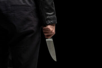 Criminal holding a knife closeup, armed attack concept.