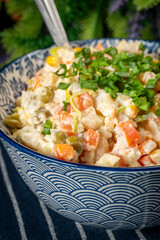 Traditional salad Olivier with boiled vegetables and mayonnaise.