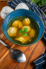 Pelmeni filled with meat served in broth.