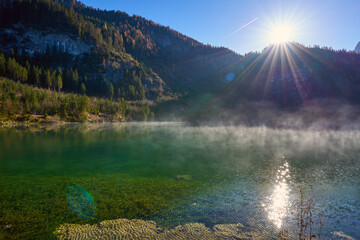 Beautiful sunset on Gosaub lake. Sunset sun and fog. Salzkammergut region.