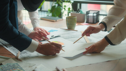 Team architects engineers designers contractors teamwork blueprints building plan on desk paperwork diverse Muslim women Indian man business working industrial sketch layout draw architectural project