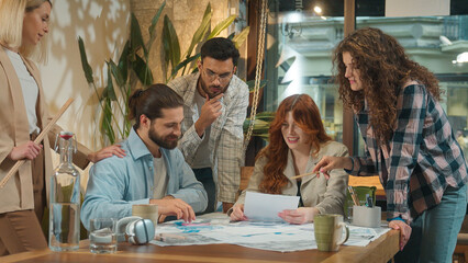 Multiracial multiethnic group coworking office team business women men girls guys male female students coworkers architects paperwork discussion blueprints project plan brainstorm corporate teamwork