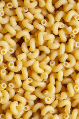 Spirali dried pasta background backdrop. Italian food ingredients concept.