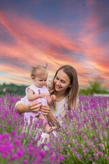 Happy mother and daughter in a lavender field