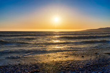 Sunset over the ocean, with beach