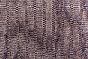 Texture of brown knitted fabric as background, top view.