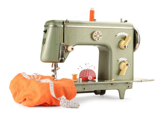 Sewing machine with orange fabric, measuring tape, pincushion and spools of threads isolated on white