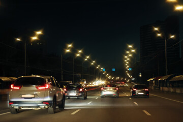 Cityscape with road traffic and street lights in evening