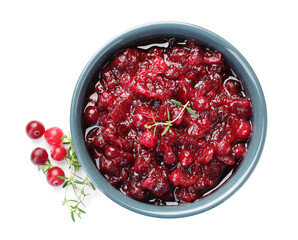 Tasty cranberry sauce in bowl, berries and thyme isolated on white, top view