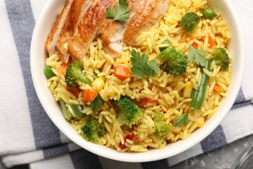 Tasty rice with vegetables and chicken on table, top view