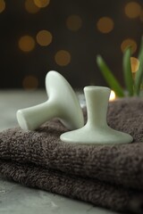Spa stones and towel on grey table, closeup