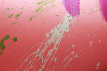 Color splashes on a pink wall texture and abstraction for interior and banner