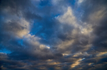 Gray clouds against a bright blue winter sky.