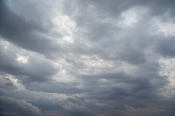 Gray sky with soft white glimpses of light on a cold winter day.