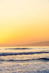 Yellow sky over ocean at sunset