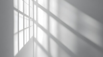 Gray window shadows and light blur creating an abstract background on a white wall.