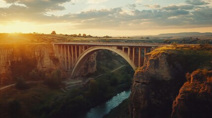 Fototapeta premium Majestic Arch Bridge at Sunset over a Gorge