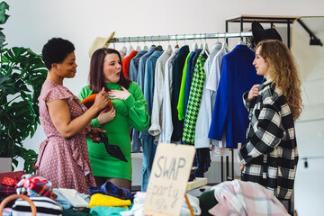 Students, young attractive people at home swap party, trying vintage clothes, bargain hunting....