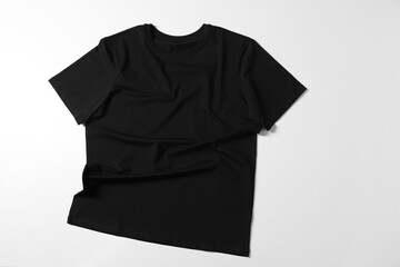 One t-shirt on light background, top view