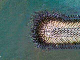 Aerial View of Coastal Protection Structures. High-angle, full shot of a precisely arranged system of large concrete blocks forming a coastal defense structure. Sakarya Karasu Turkiye ADAPAZARI 