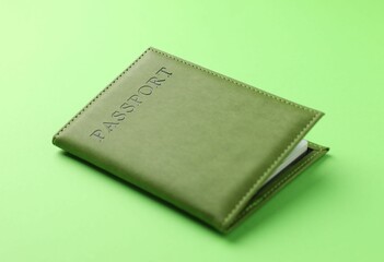 Passport in color cover on green background, closeup
