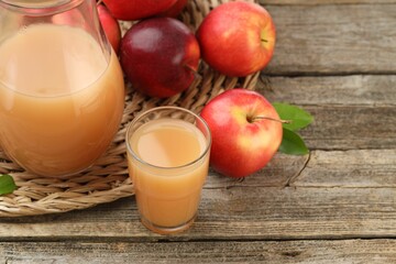Tasty apple juice and fresh fruits on wooden table, closeup