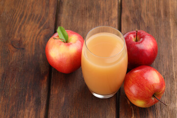 Tasty apple juice and fresh fruits on wooden table, closeup