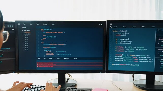Slow motion back end software developer engineer for computer programming working together on debugging writing computing code, solving complex algorithms display on monitor in office. Burgeoning