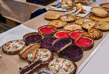 Variety of colorful homemade pies and tarts displayed on a table