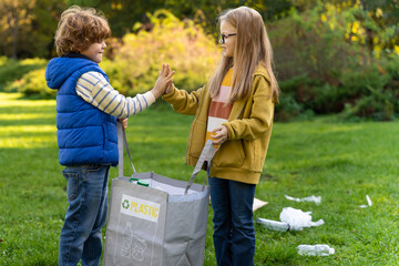 Caucasian kids boy and girl volunteering outdoors cleaning pollution and recycling garbage
