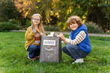 Little children picking up trash in park participating in a community project