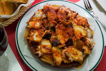 Pulpo a la gallega, spanish seafood dish of baked octopus tentacle with boiled potatoes