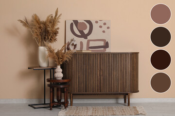 Chest of drawers, pampas grass in vases and picture near brown wall in room