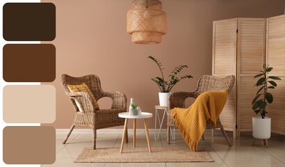 Interior of modern room with comfortable wicker armchairs, folding screen and table near brown wall. Different color patterns