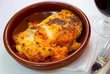Italian meat lasagna in a clay plate. High quality photo