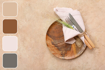 Wooden plate with cutlery and spikelet tied in napkin on brown grunge table