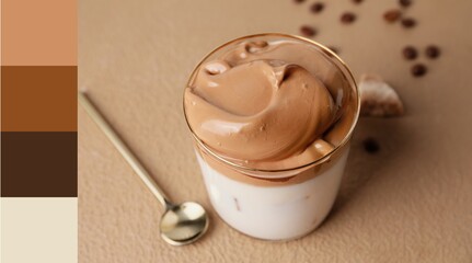 Glass of tasty dalgona coffee on beige background. Different color patterns