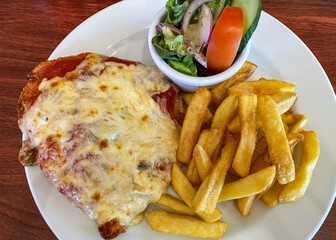Australian Chicken Parmesan With Chips And A Small Salad