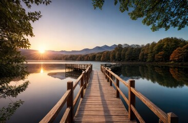 Naklejka premium A serene lakeside scene at sunrise with a wooden pier leading into calm reflective waters, surrounded by lush trees, distant mountains, and golden sunlight illuminating the peaceful landscape