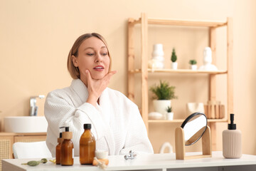 Woman doing face building exercise in bathroom