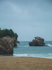 Biarritz coastline with beach blue sea and overcast rainy weather