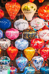 background with colorful Vietnamese silk lanterns in Vietnam in Asia in the old town on streets of Hoi An city at night