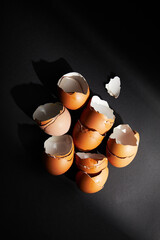 Cracked egg, eggshells isolated on black background