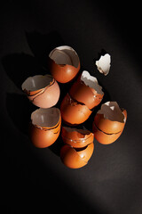 Cracked egg, eggshells isolated on black background