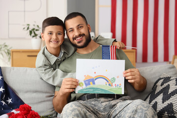 Little boy and his military father with drawing at home. Veterans Day celebration
