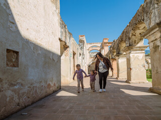 Family plays in the corridors of an old colonial house. Colonial house, tourist attraction in Antigua Guatemala.
